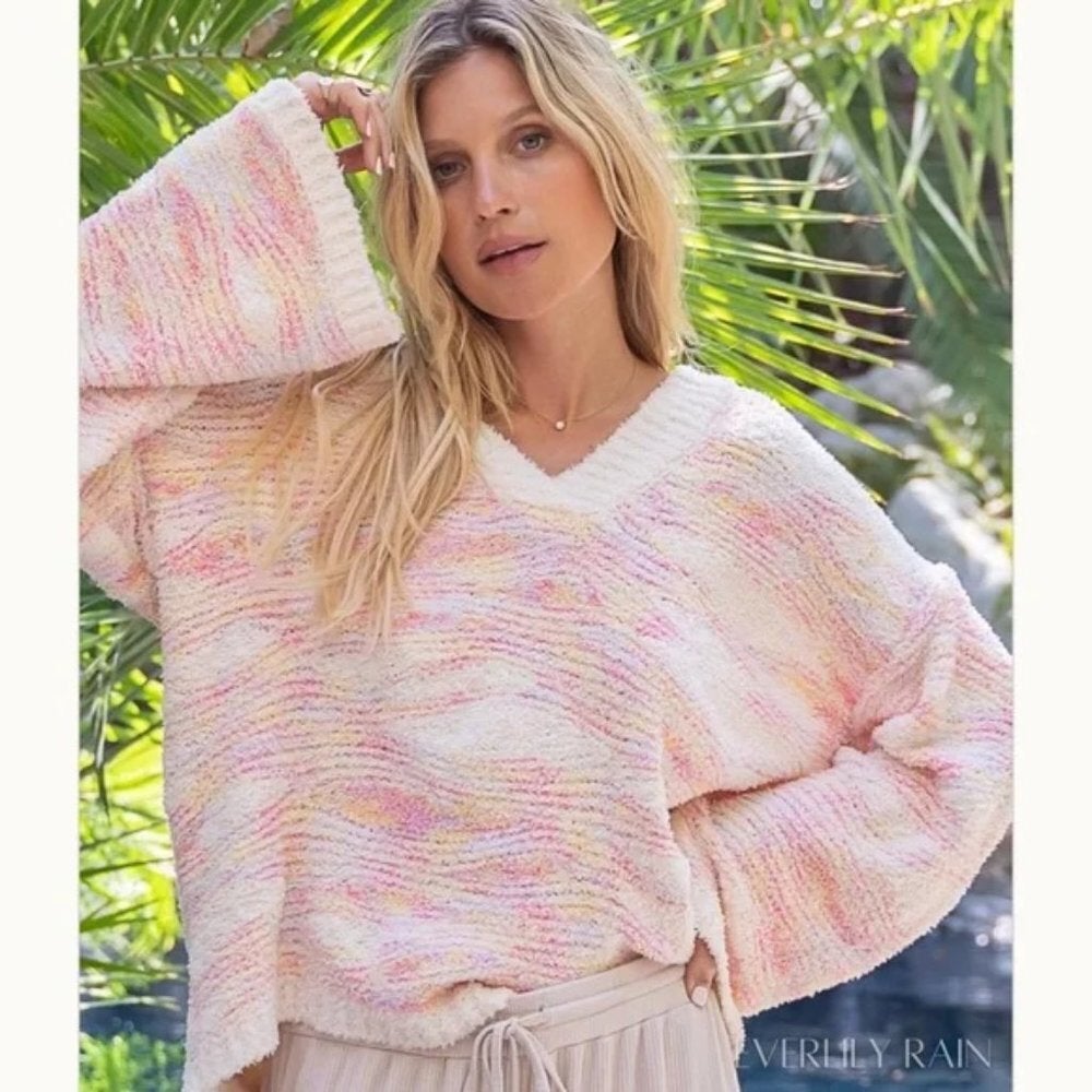 Super soft pink and creme oversized sweater with bell sleeves and v-neck.